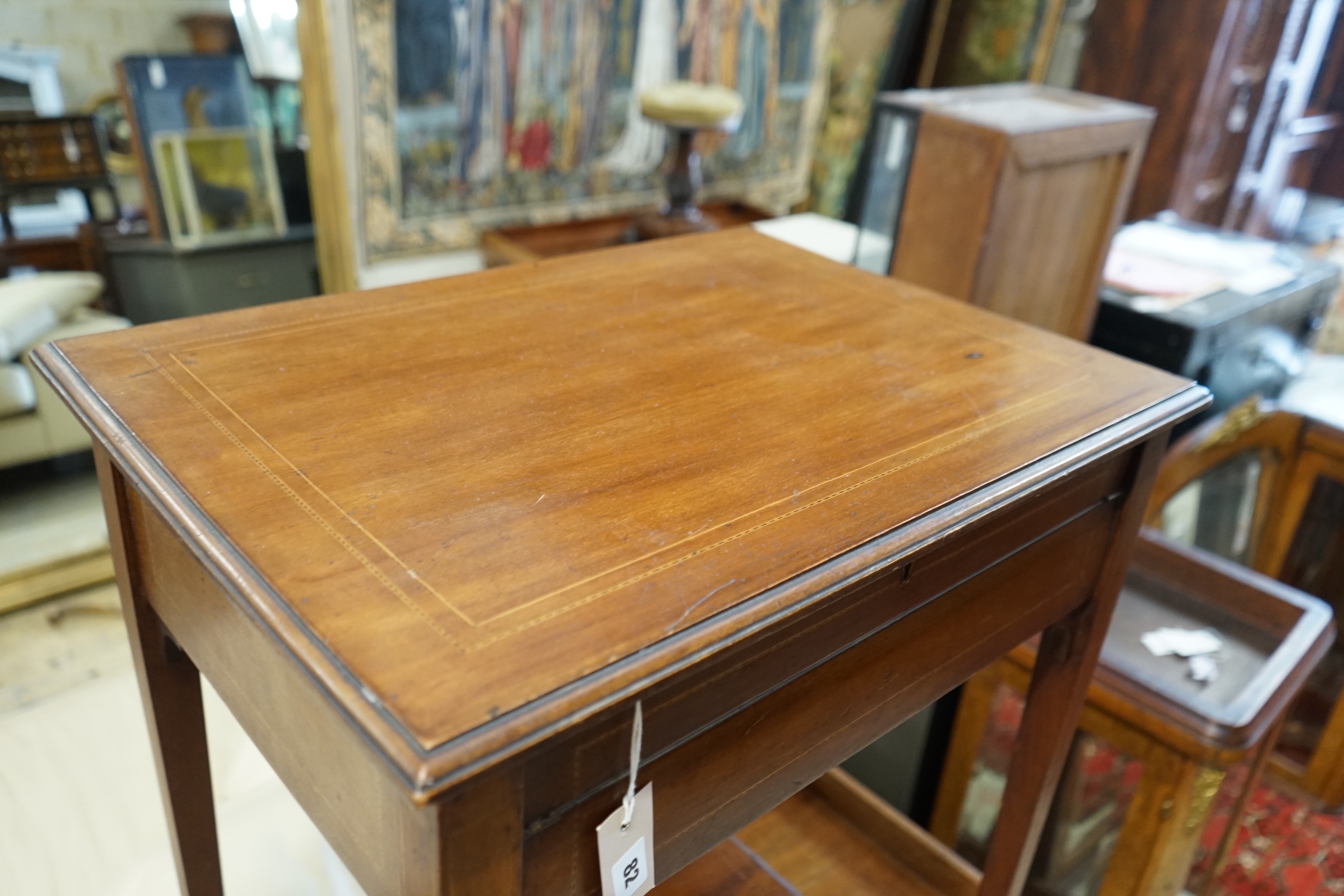 An Edwardian rectangular mahogany hinged top writing table, width 62cm, depth 45cm, height 74cm